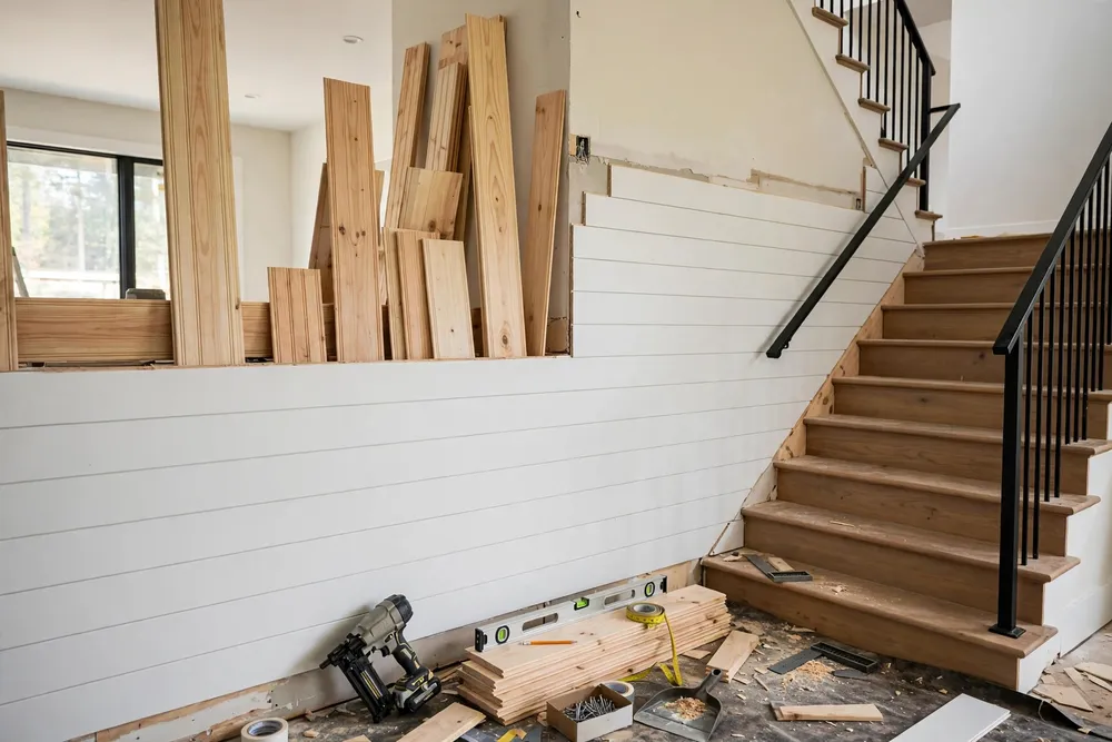 Shiplap and tongue and groove boards as textured staircase wall decor